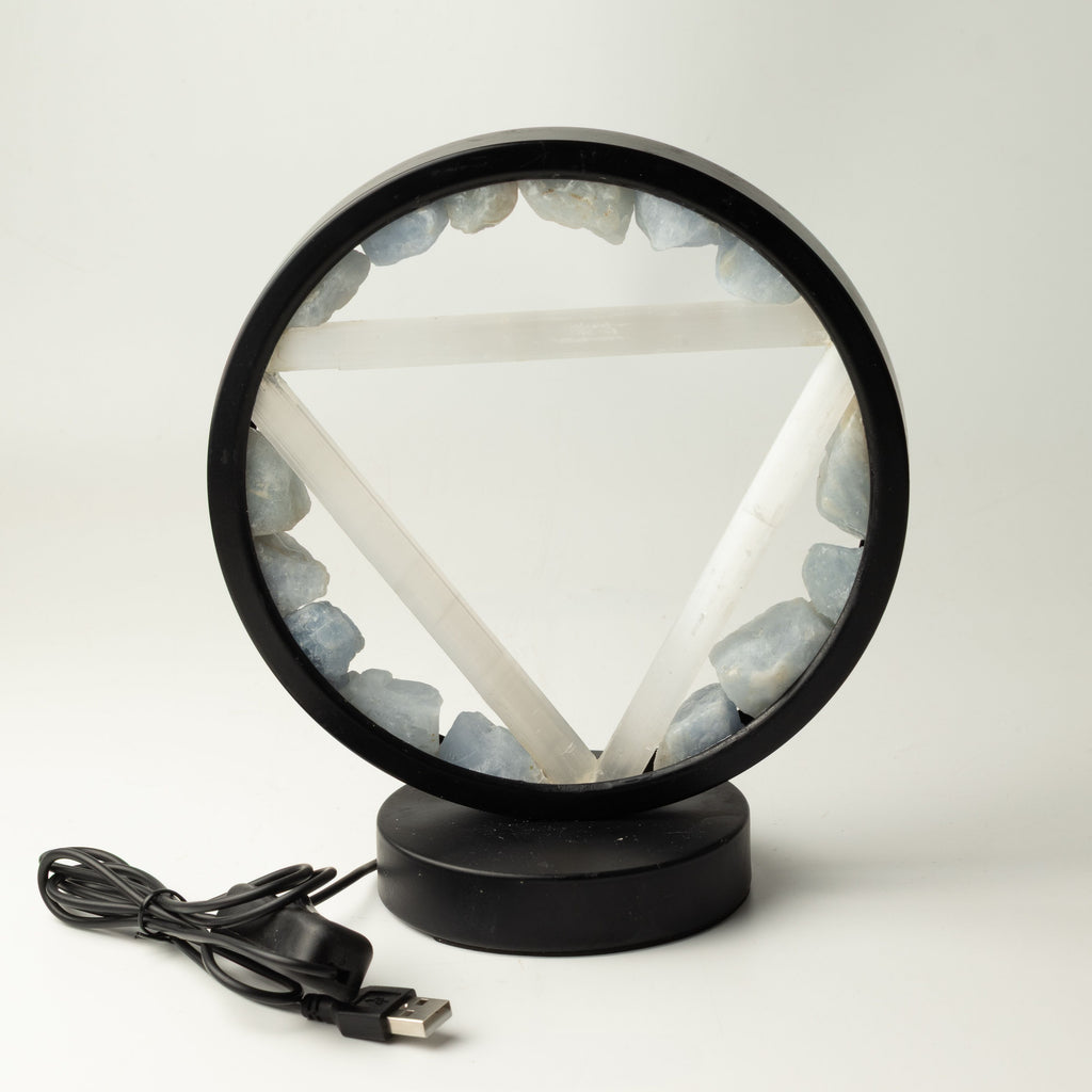 A circular black-framed LED lamp featuring a white pentagram design and light blue crystal stones around the inner ring, shown on a white background with its USB charging cable.